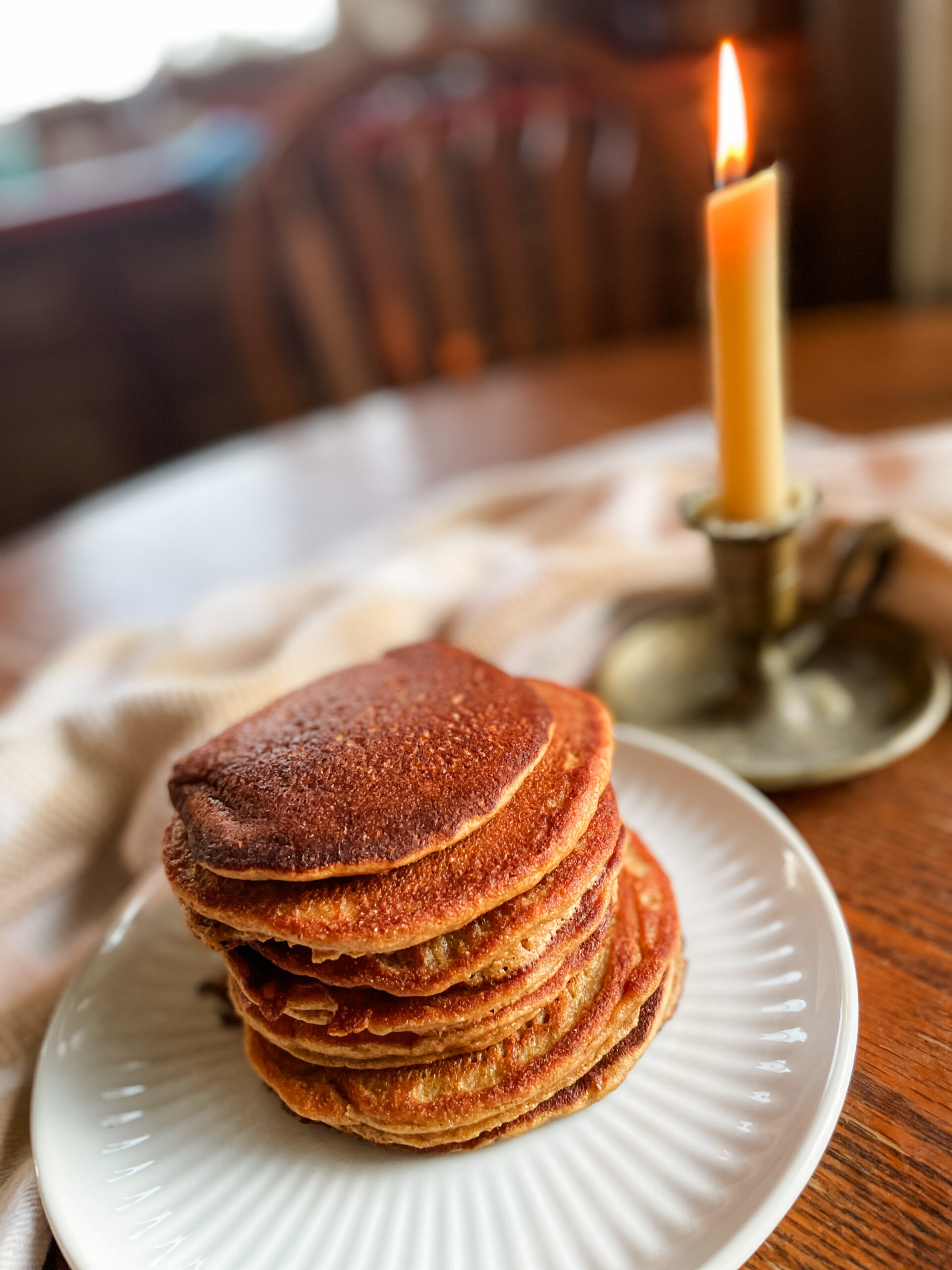 pancakes on a plate with a candle