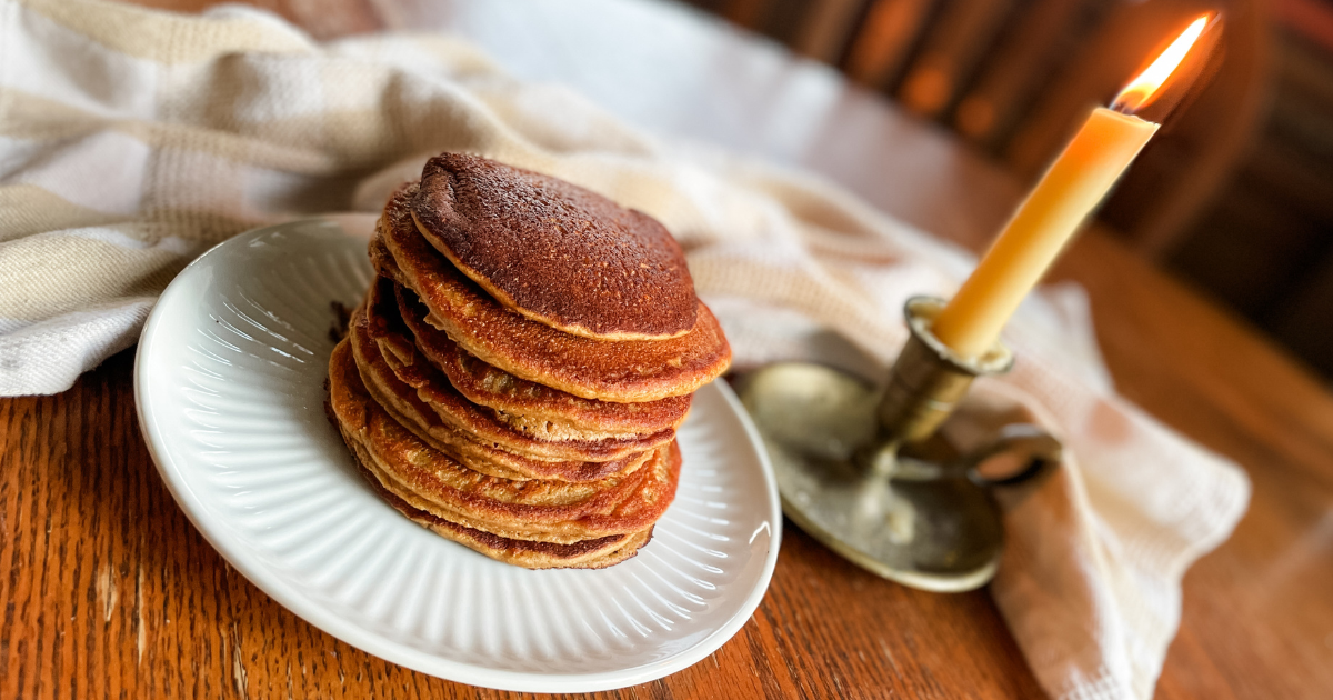 pumpkin pancakes on plate with a candle